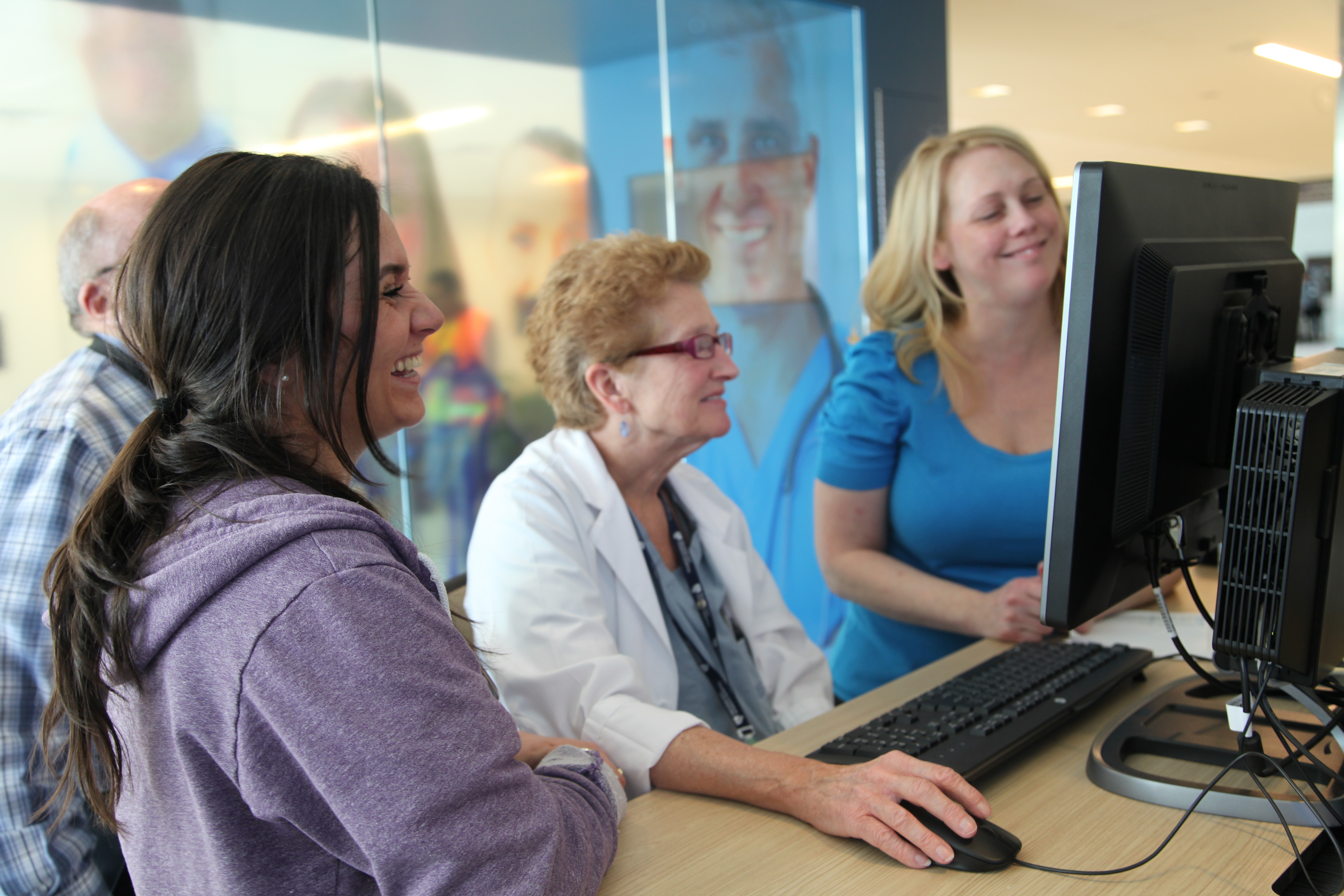 Jessica Sauls (far right), of Information Systems, with respiratory therapists Gabriella Andrade (at left) and Jane Bartholomew in the eCare information center