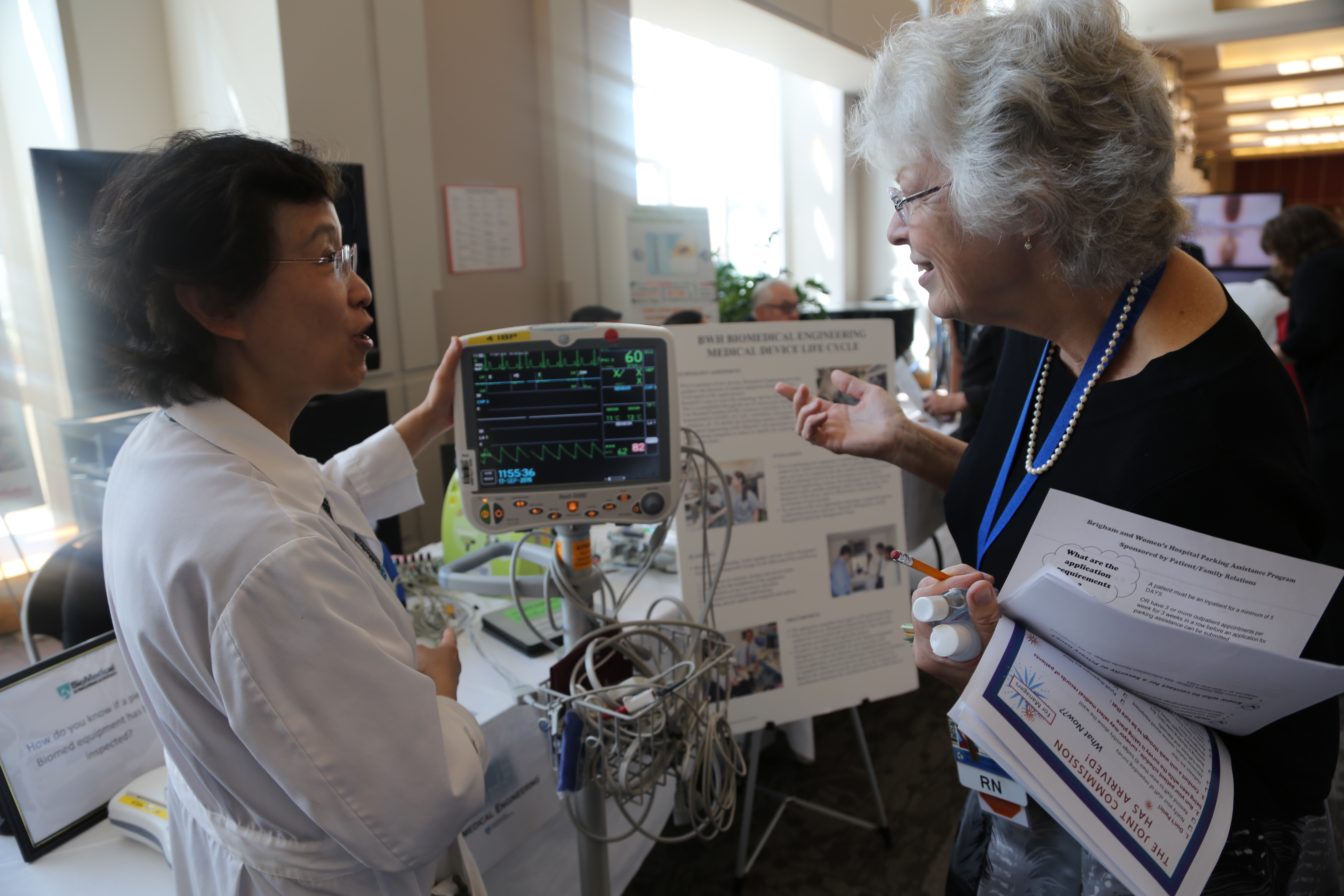 From left: Xiaojie Liu, of Biomedical Engineering, and Brenda Griffin, of Nursing, at BWH’s Joint Commission Readiness Fair last September.