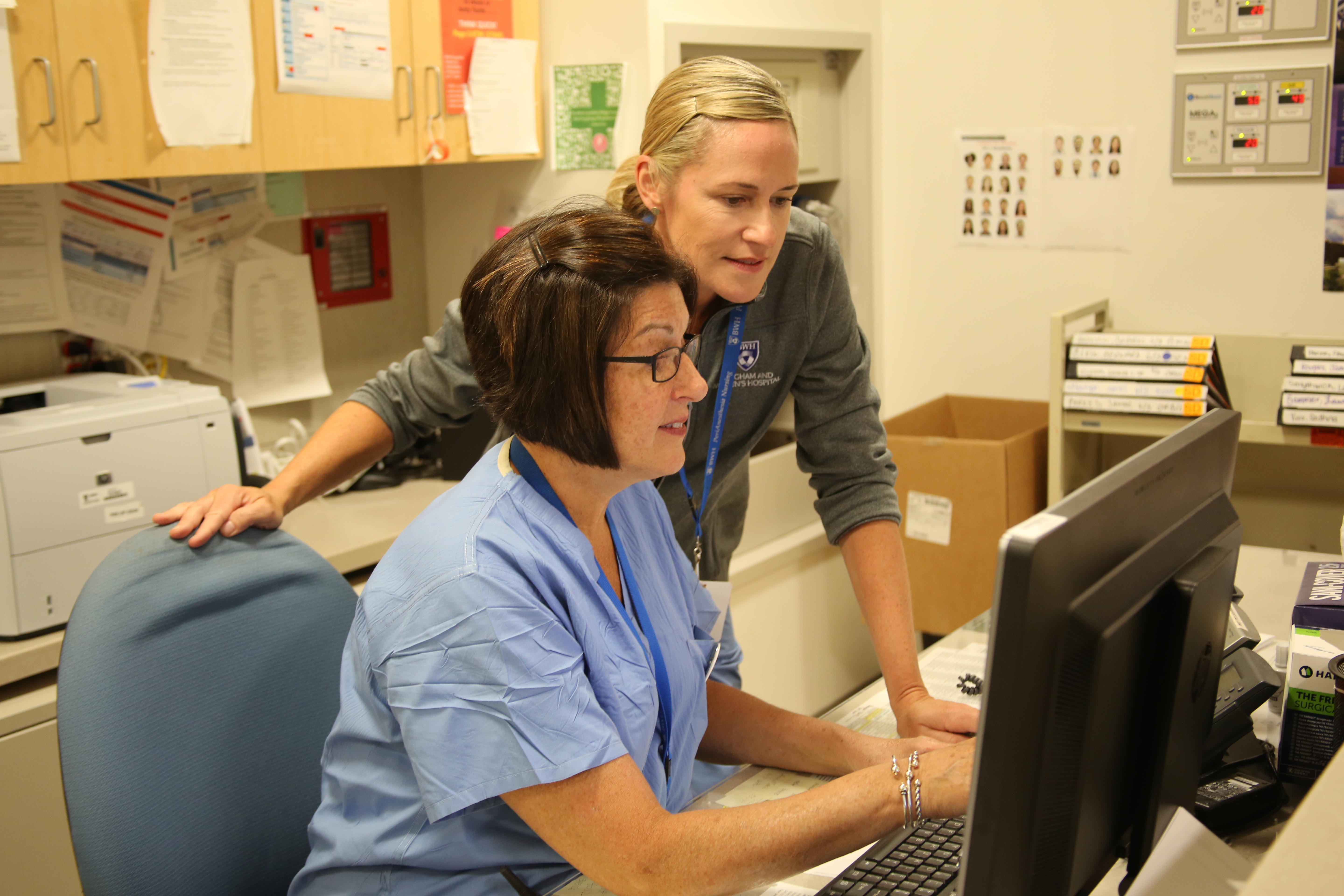 Operating Room nurses Cynthia Engel, seated, and Roberta Bernard review information in Partners eCare.