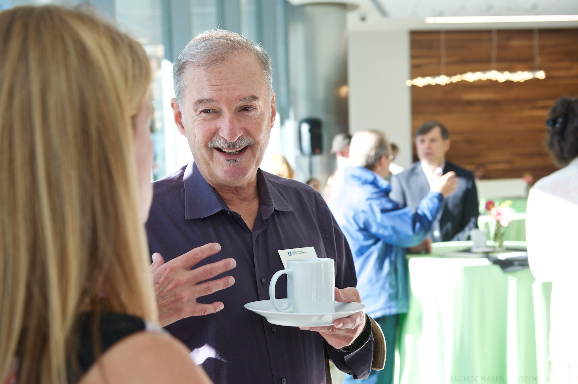 Local artist Tom Stocker, whose artwork is featured in the building, chats at the breakfast.