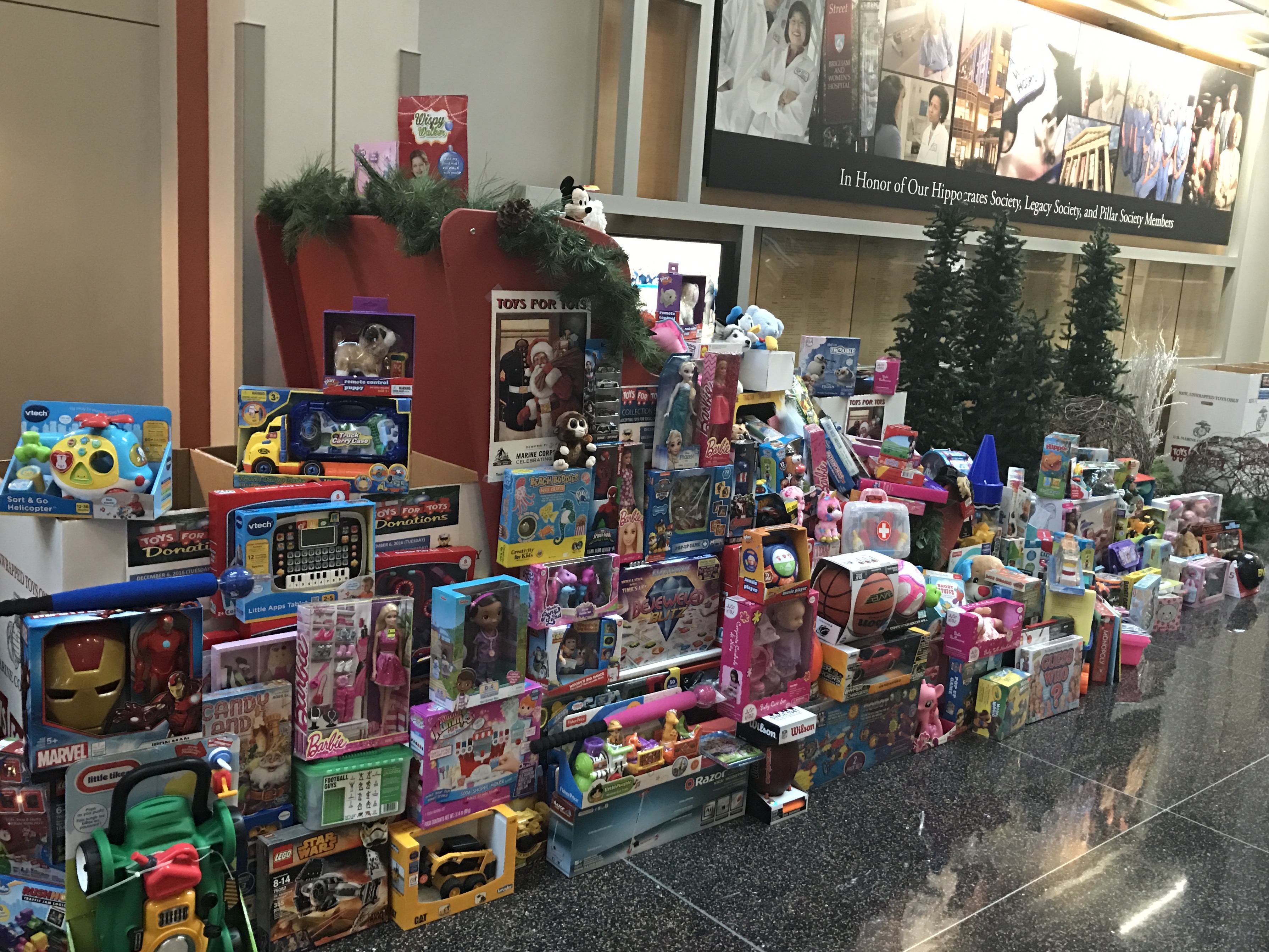 A sleigh in the main lobby overflows with donations for Toys for Tots.