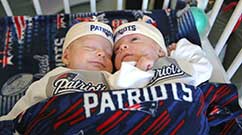 Benjamin and Samuel snuggle in their Patriots gear