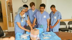 From left: Michaela Farber simulates an epidural injection for Christopher Zhu, Ian Richardson, Nick Chehwan and John Harrington