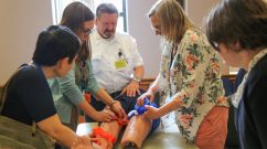 Dan Scanlon (center) of Fallon Ambulance instructs Brigham staff on bleeding-control techniques during a recent training.