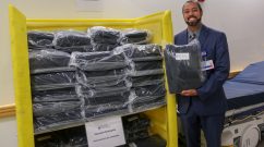 Jonathan Santiago displays one of the disposable bedding kits available to EMS personnel outside the Emergency Department.